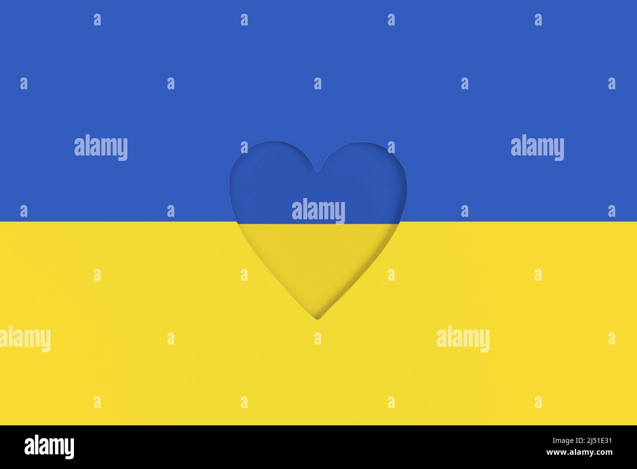 Ukraine flag on Printed cardboard with die-cut heart shape inside. Top view Stock Photo