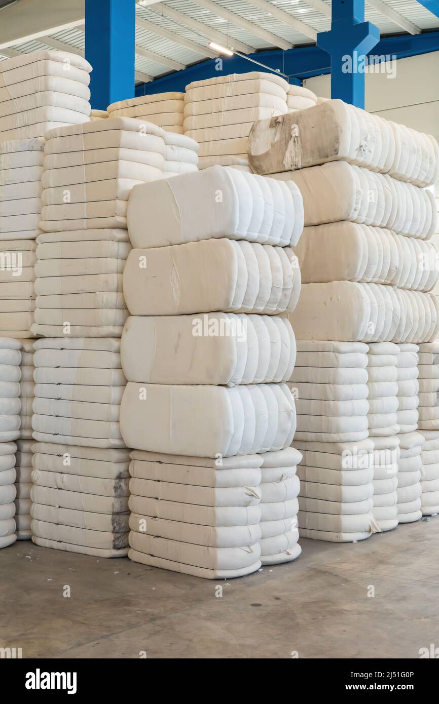 Pile or stack of cotton bales at textile factory or industry Stock