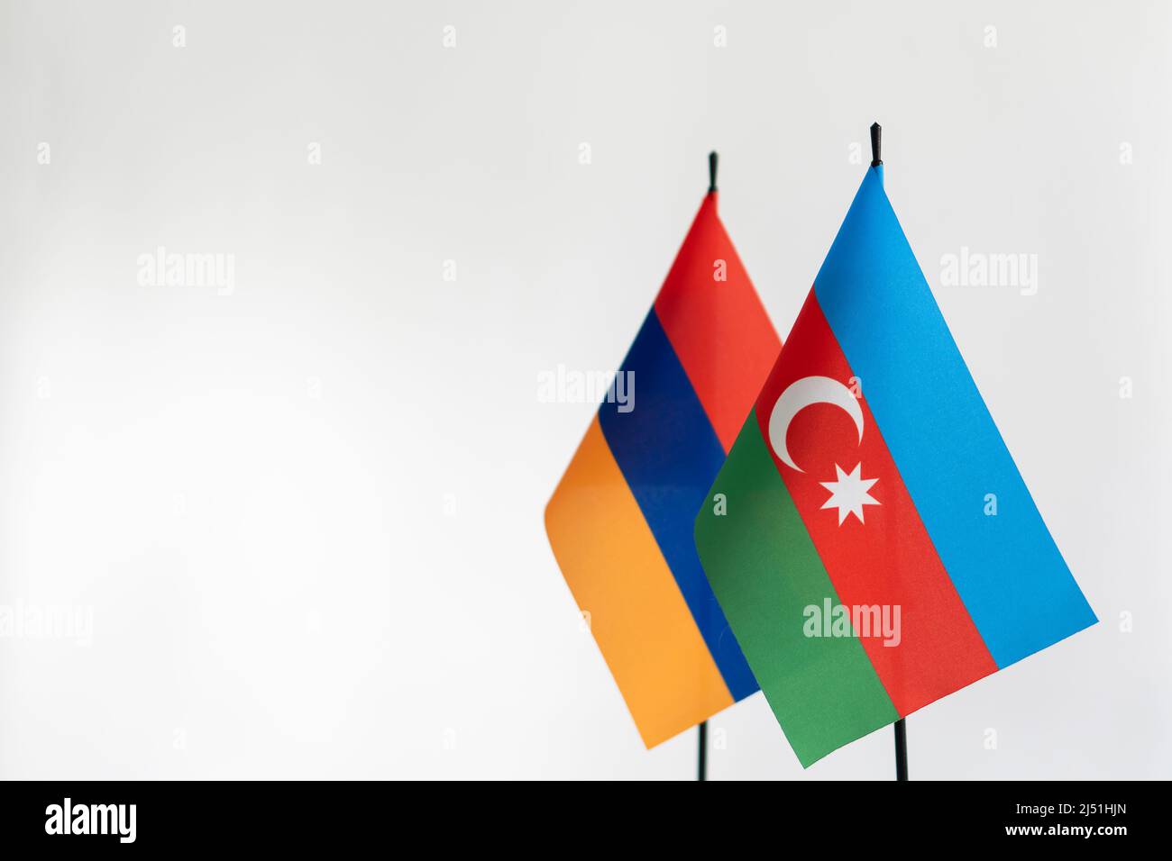 State flags of Azerbaijan and Armenia on light background. Karabakh conflict concept. Place for text Stock Photo