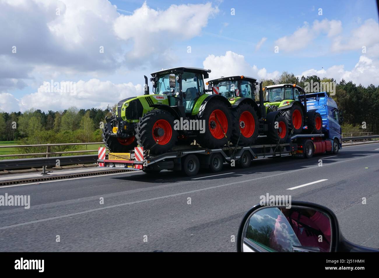 Three tractors being transported on a MDF haulage transportation along the A12 in the Uk Stock Photo