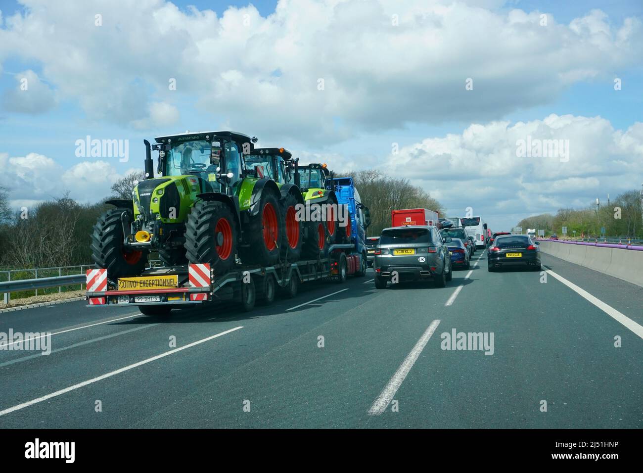 Three tractors being transported on a MDF haulage transportation along the A12 in the Uk Stock Photo