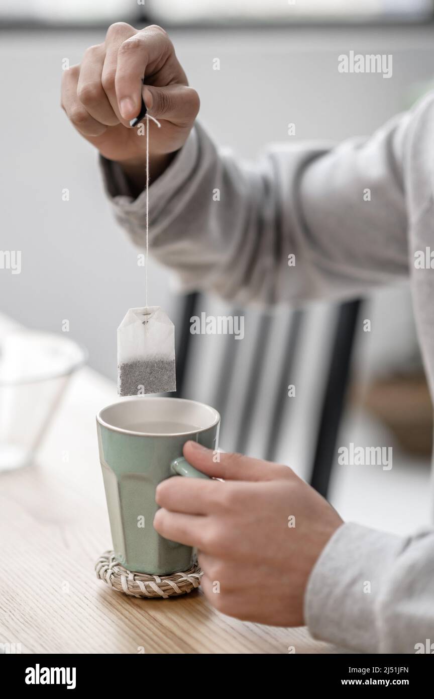 A man spending morning at home and preparing tea Stock Photo