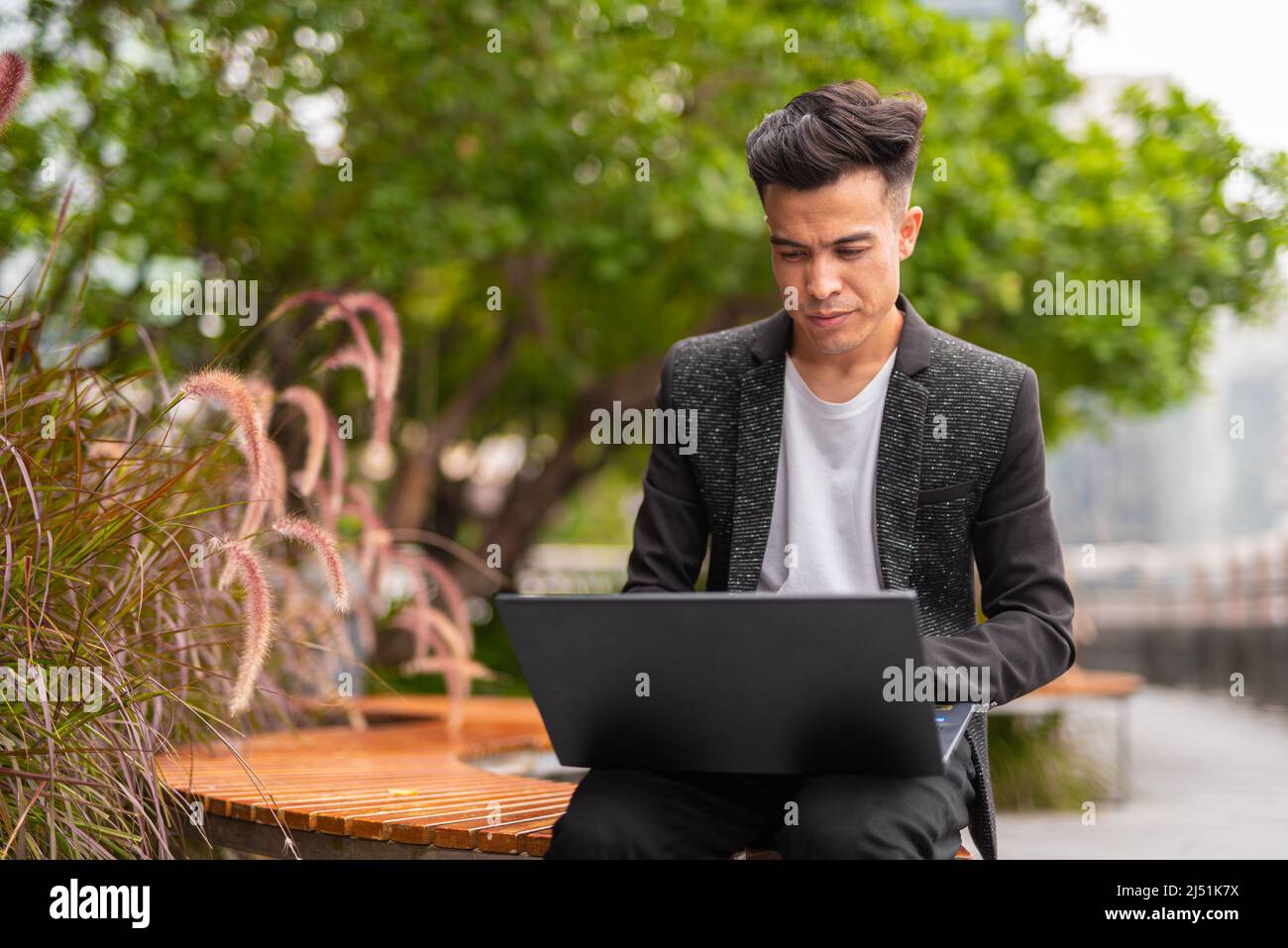 Portrait of handsome young businessman in city Stock Photo - Alamy