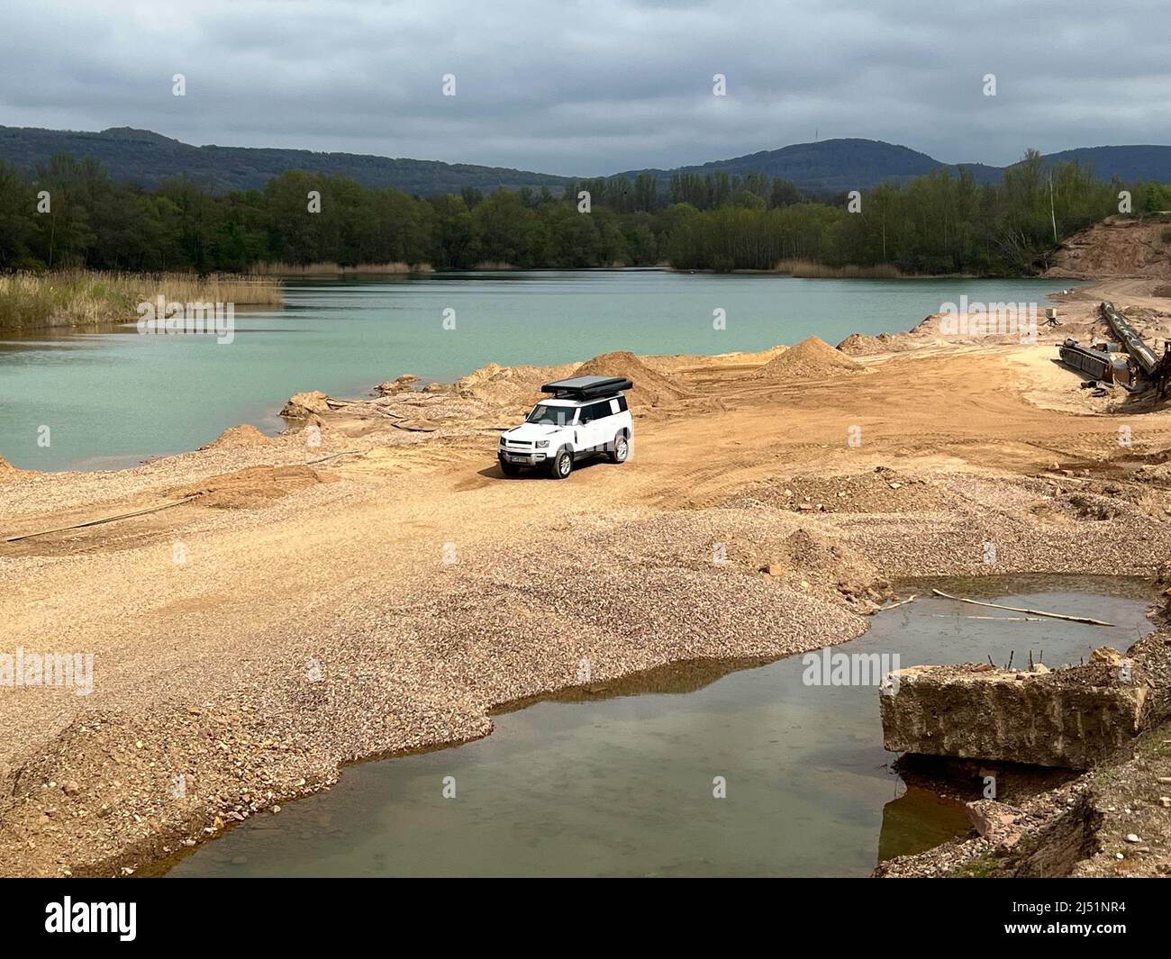 4x4 Offroad vehicle (SUV) at a lake side in the mountains Stock Photo