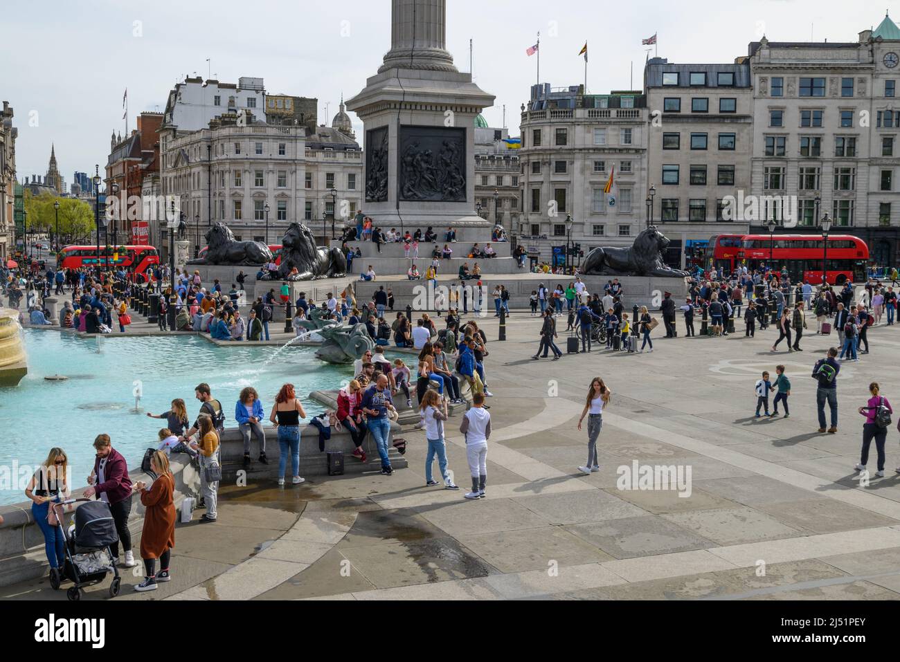 Crowds of people in warm sunny weather at Easter in Trafalgar Square, London, UK, April, 2022 Stock Photo