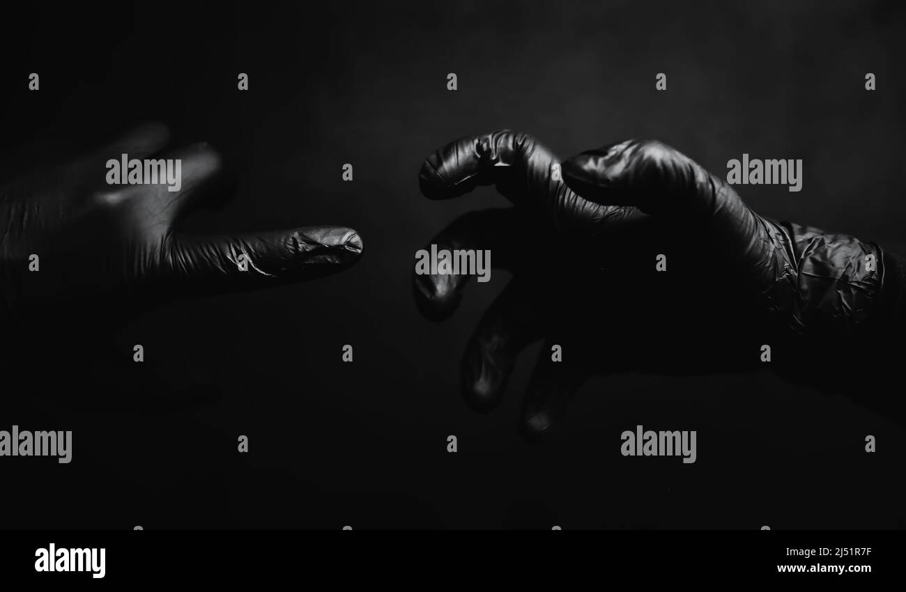 Background of hands in gloves. Black gloves. Hand gestures black gloves