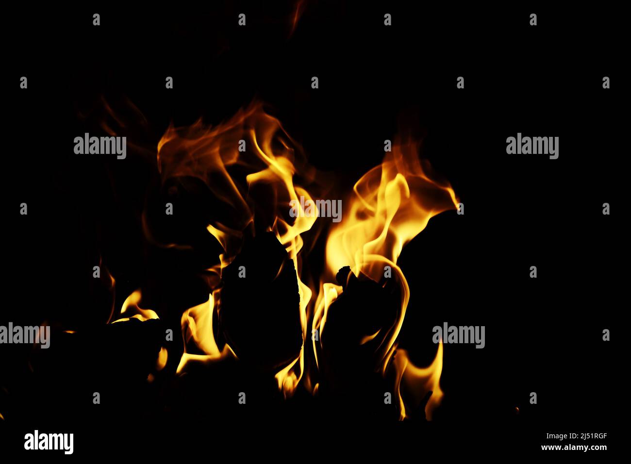 Background of the flame in the oven. Tongues of fire in brick fireplace. Fire texture. Stock Photo