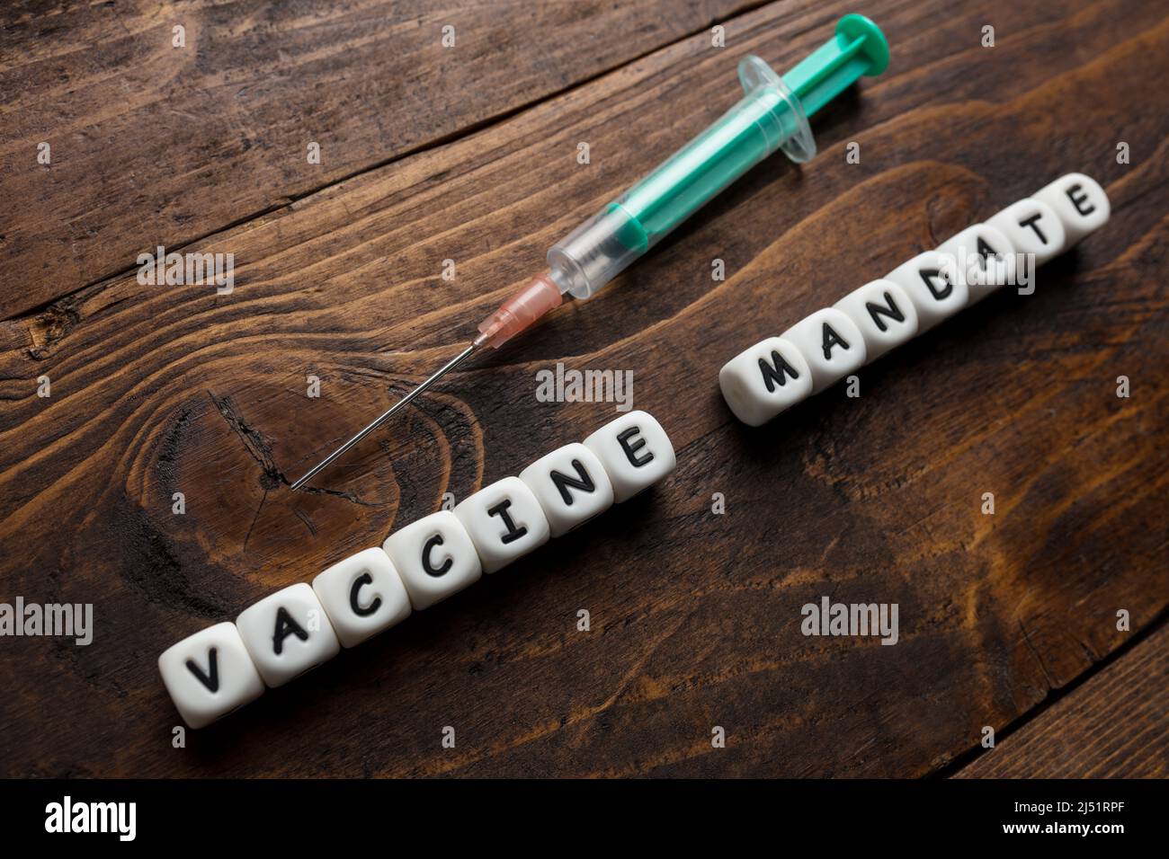 Corona virus Covid-19 vaccine text on wooden background Stock Photo
