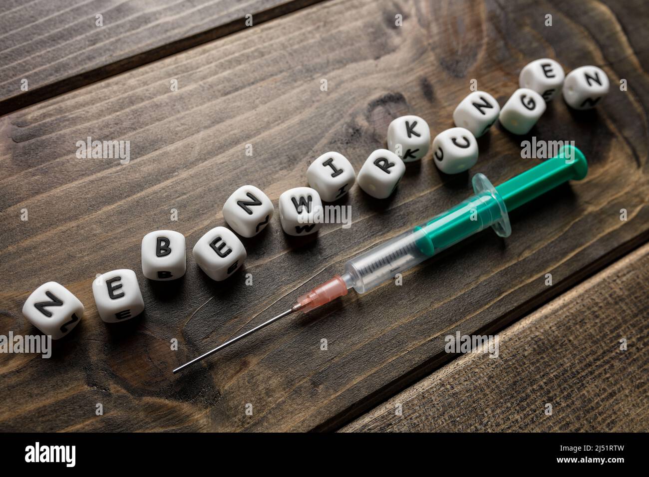 Corona virus Covid-19 vaccine text in German on wooden background Stock Photo