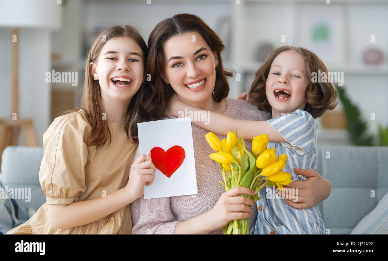 Happy mother's day. Children daughters are congratulating mom and ...