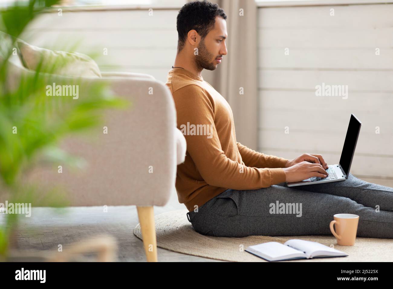 Arab man sitting in sofa hi-res stock photography and images - Alamy