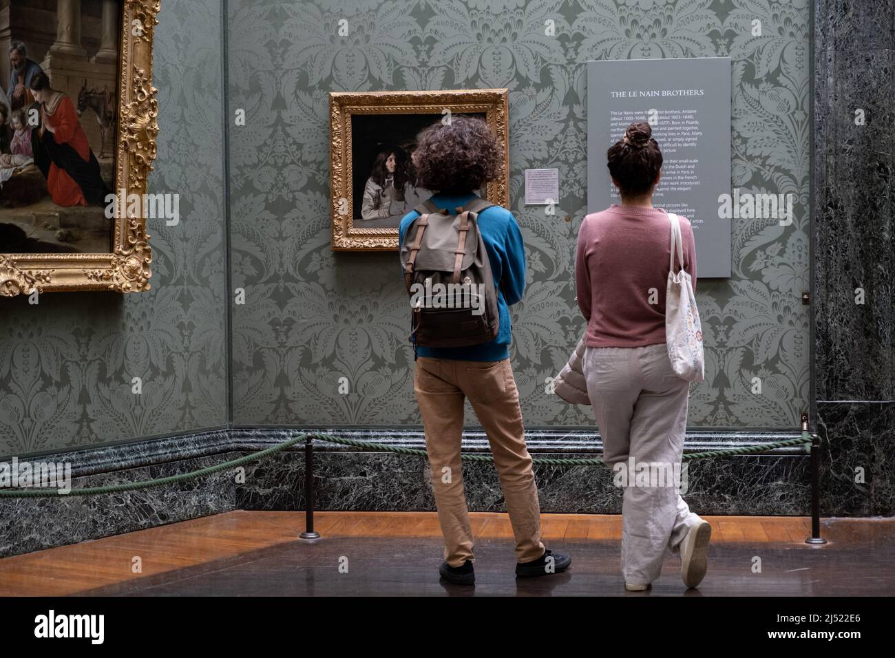 Looking at art in The National Gallery in London, England. Stock Photo