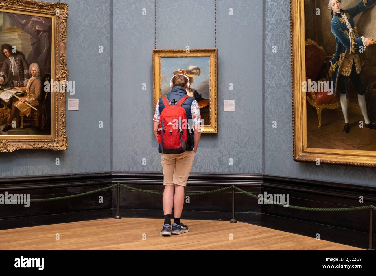 Looking at art in The National Gallery in London, England. Stock Photo