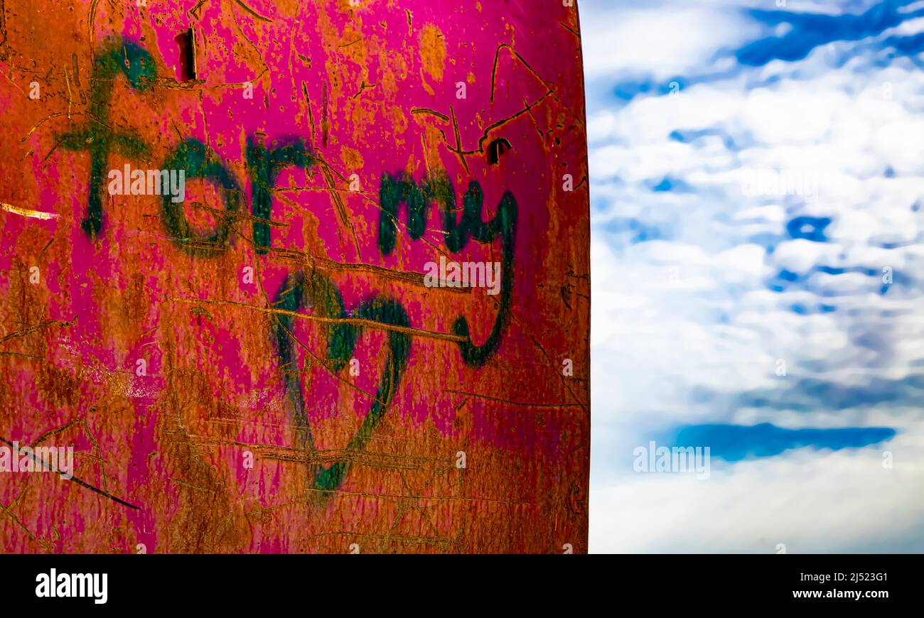 Text 'for my ?' painted on pink waste container. Sky in the background. Stock Photo