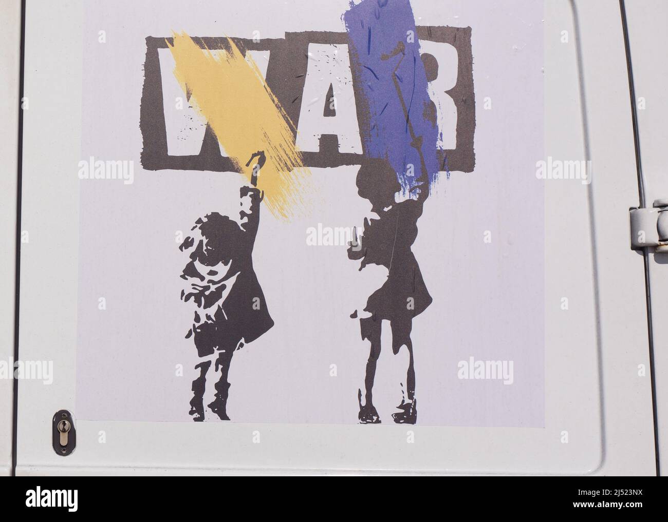 Support for Ukraine against the war art work with 2 children painting the Ukraine colours over the word war Stock Photo