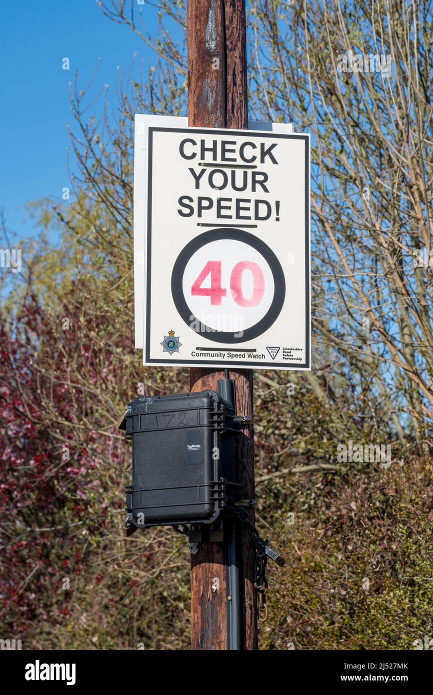 Check your speed notice on post above traffic management black box Stock Photo