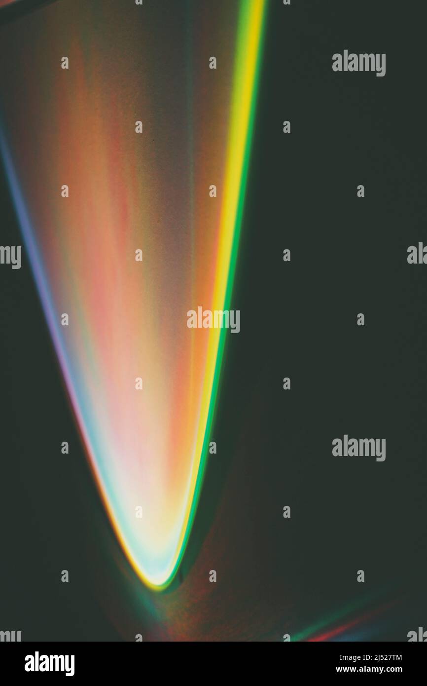 Abstract image of colorful shapes of light against black background ...