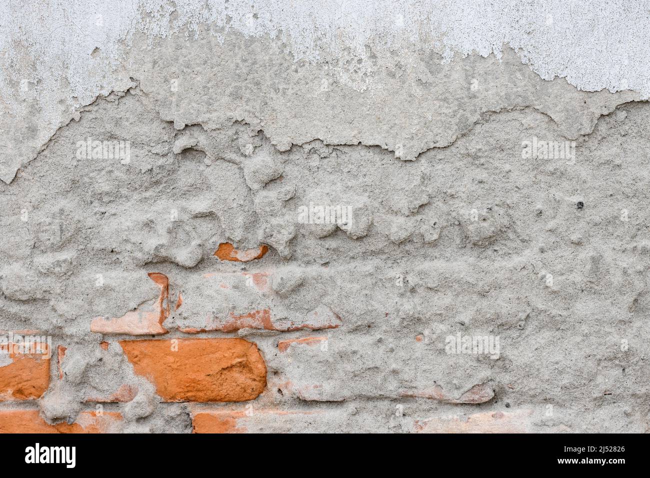 Damaged brick structural concrete plaster wal Stock Photo