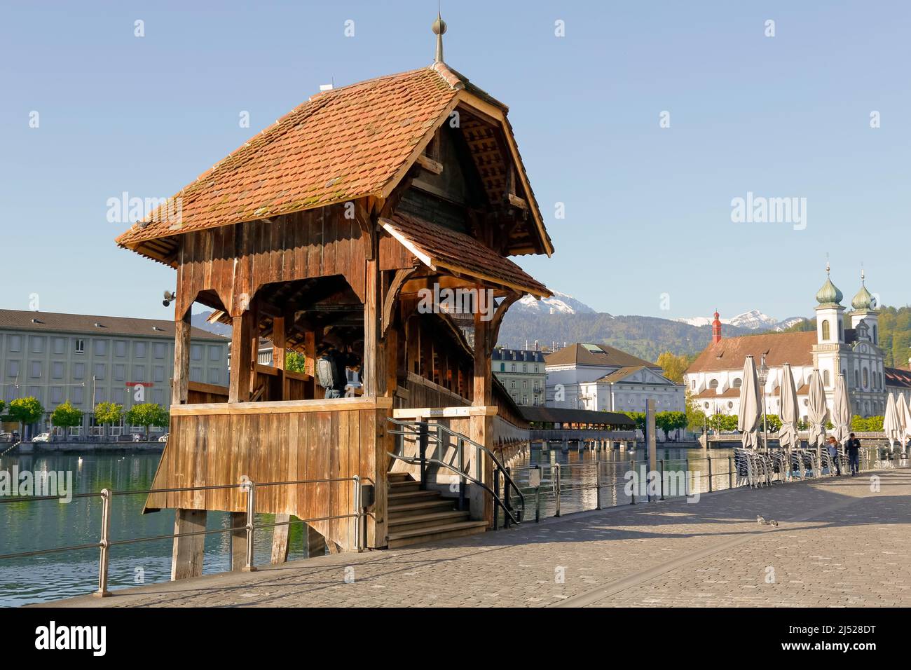 Lucerne, Switzerland - May 05, 2016: Entry to roofed wooden the Chapel Bridge that connects the two banks of the Reuss river and it is one of the Luce Stock Photo