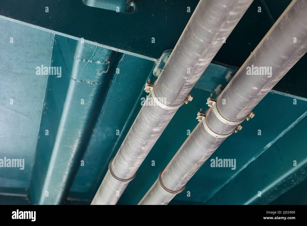 Pipelines below metal structure, urility tubes Stock Photo