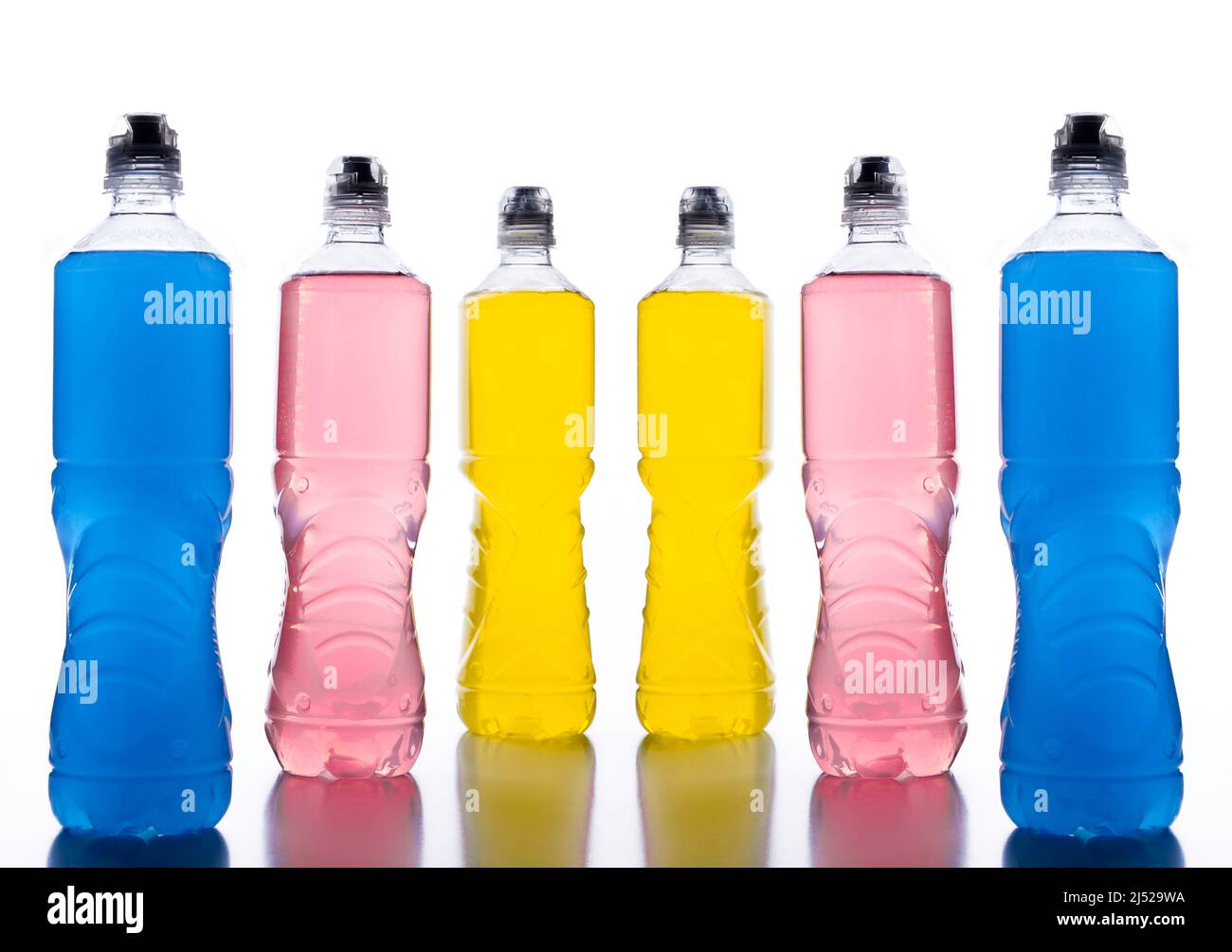 Plastic bottles with colored liquid. Colored bottles of sports nutrition,  isotonics Stock Photo - Alamy