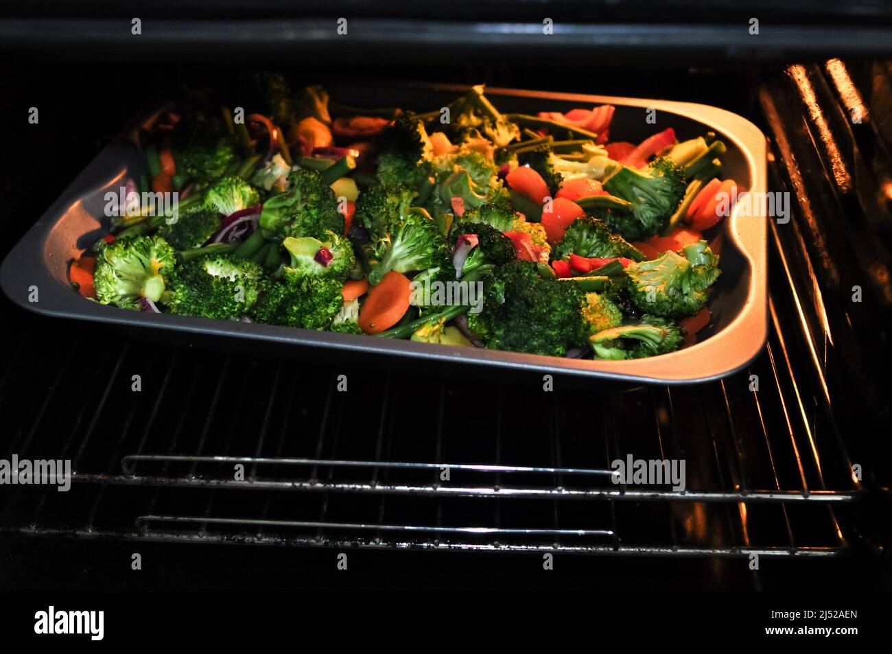 Fried vegetables broccoli pepper and bean in the oven, healthy eating Stock Photo