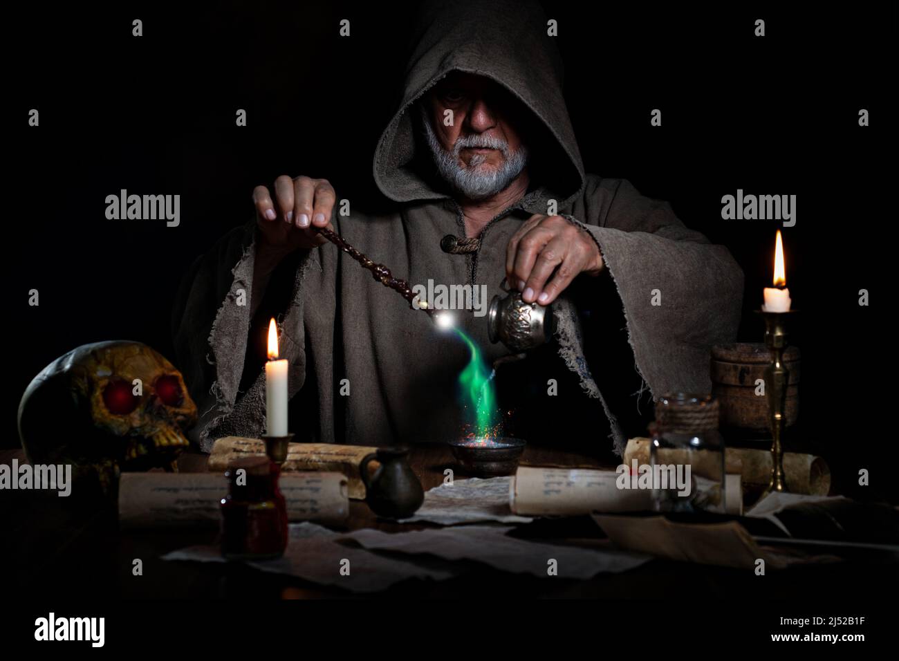 Old magician performs mystical magic Stock Photo
