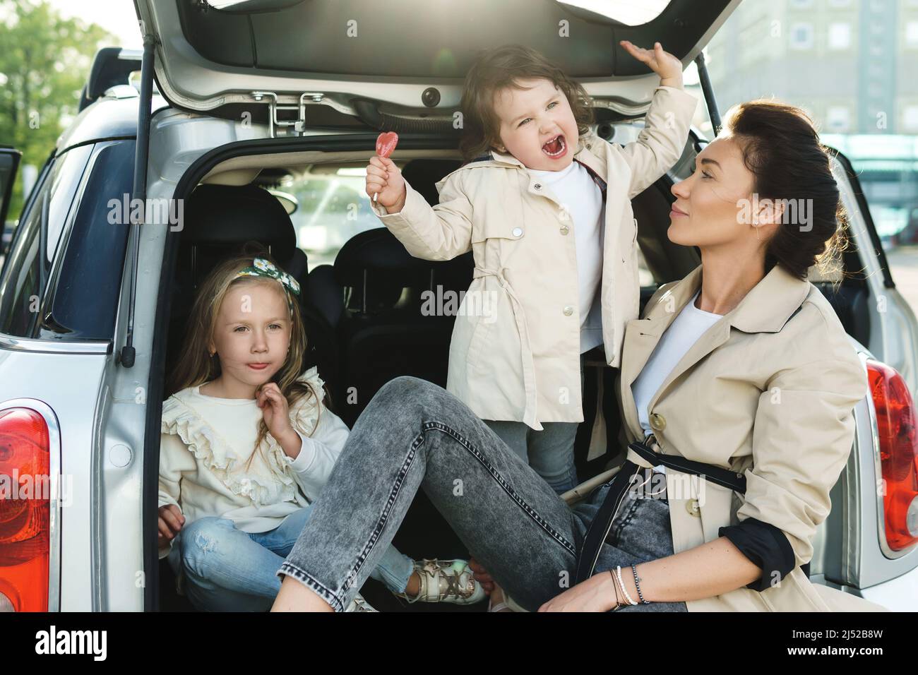 Happy family ready for a road trip. Young mother and her adorable ...