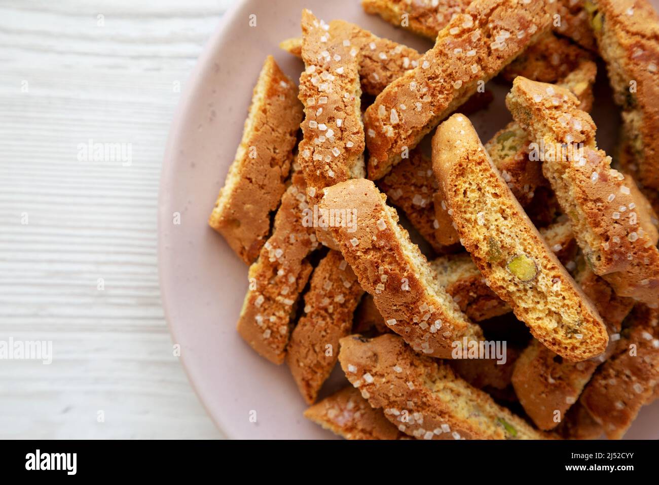 Homemade Italian Cantuccini with Pistachios and Citron on a Plate, top view. Crispy Pistachio and Citron Cookies. Flat lay, overhead, from above. Copy Stock Photo