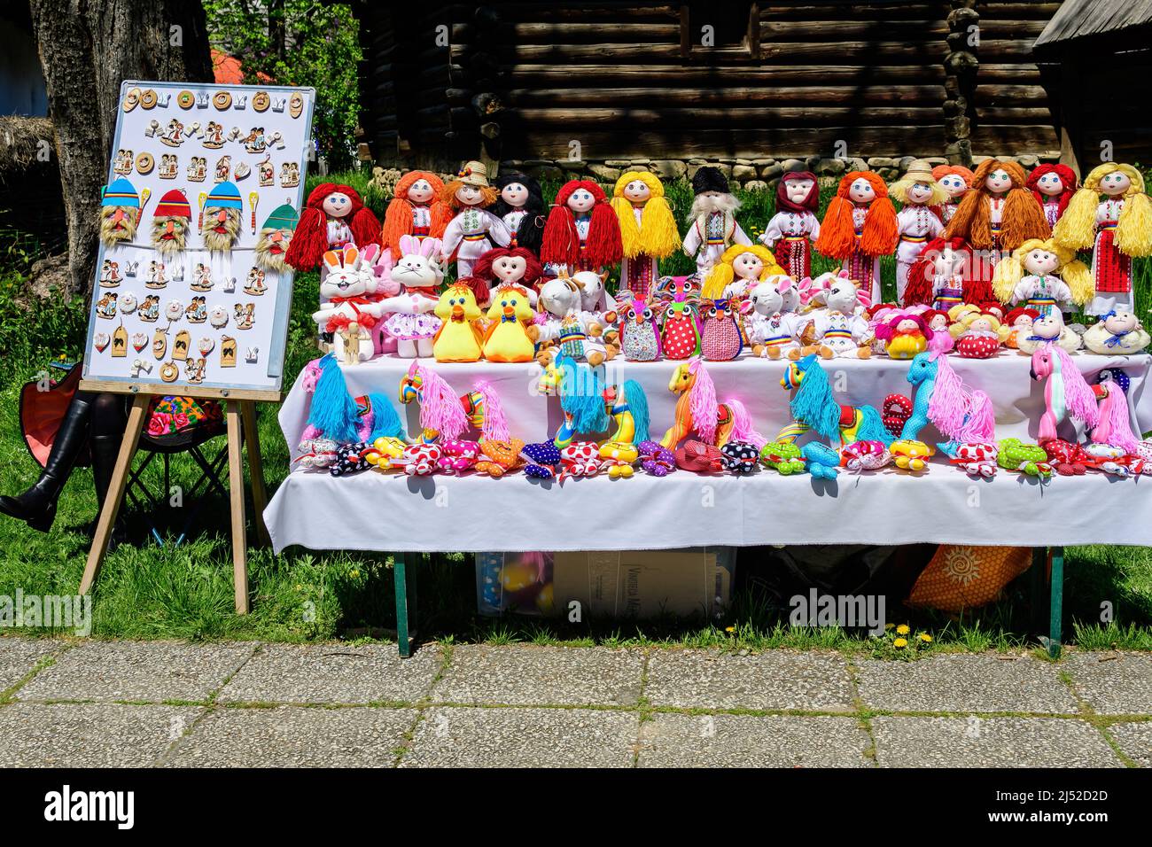 Group of colourful textile traditional hand made decorations, dolls and  toys for children, available for sale at a traditional weekend market in a vi Stock Photo