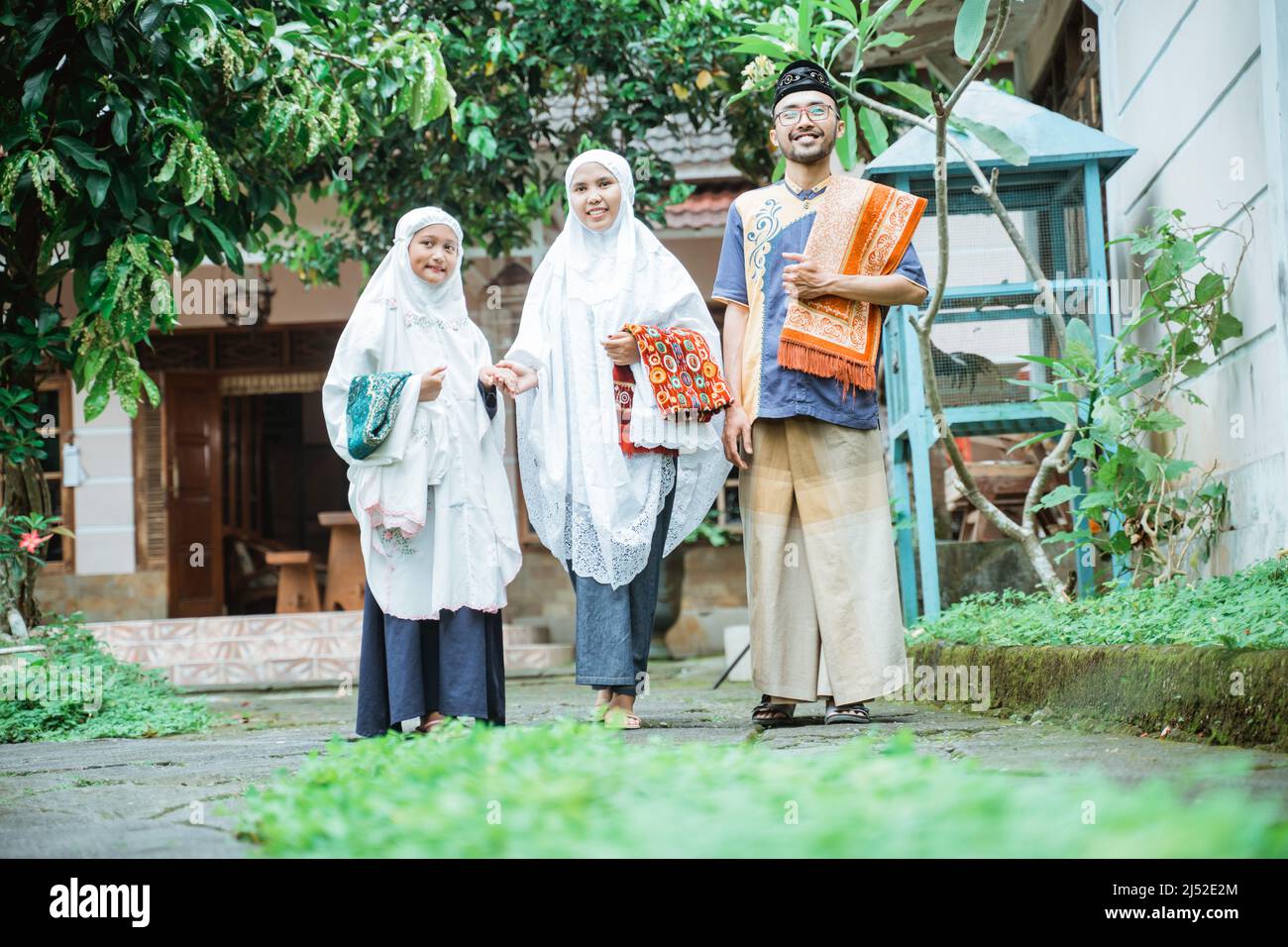 family going to the mosque to do idul fitri or eid mubarak prayer Stock Photo