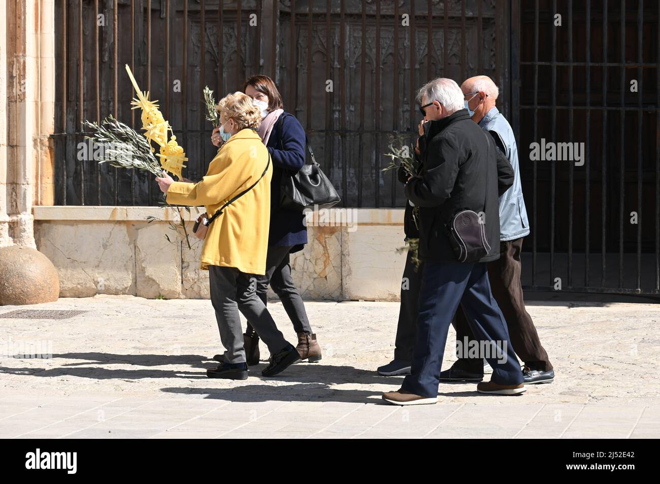 Worshipers leave the Cathedral of Palma de Mallorca on Palm Sunday with blessed palm fronds Stock Photo