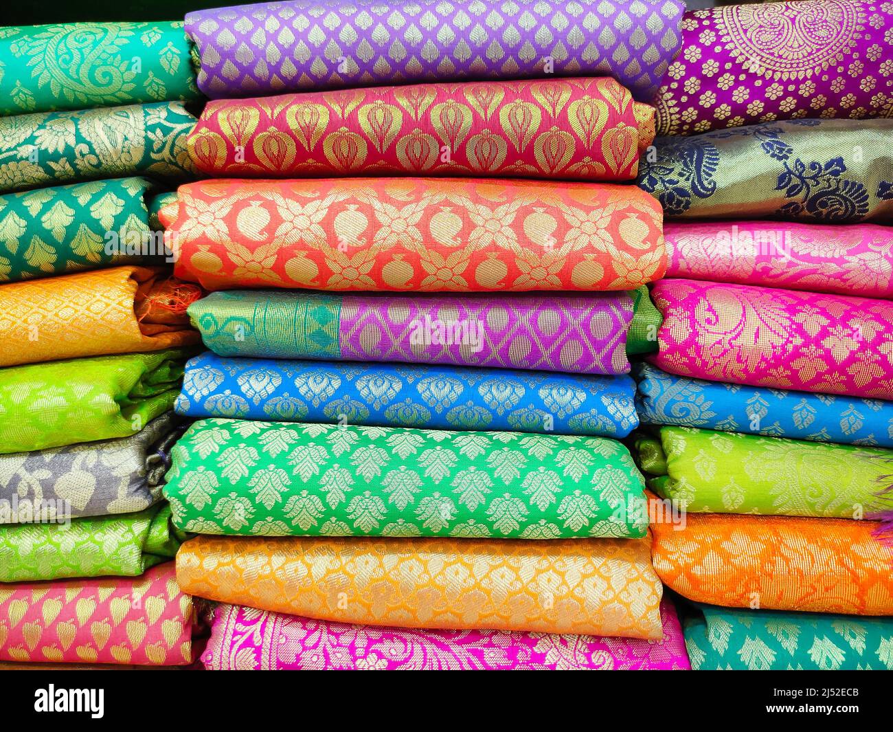 Rolls of fabric and textiles in shop. Multi colors indian patterns on the market Fabrics in rolls. Fabric store in Pune, Maharashtra, India. Stock Photo