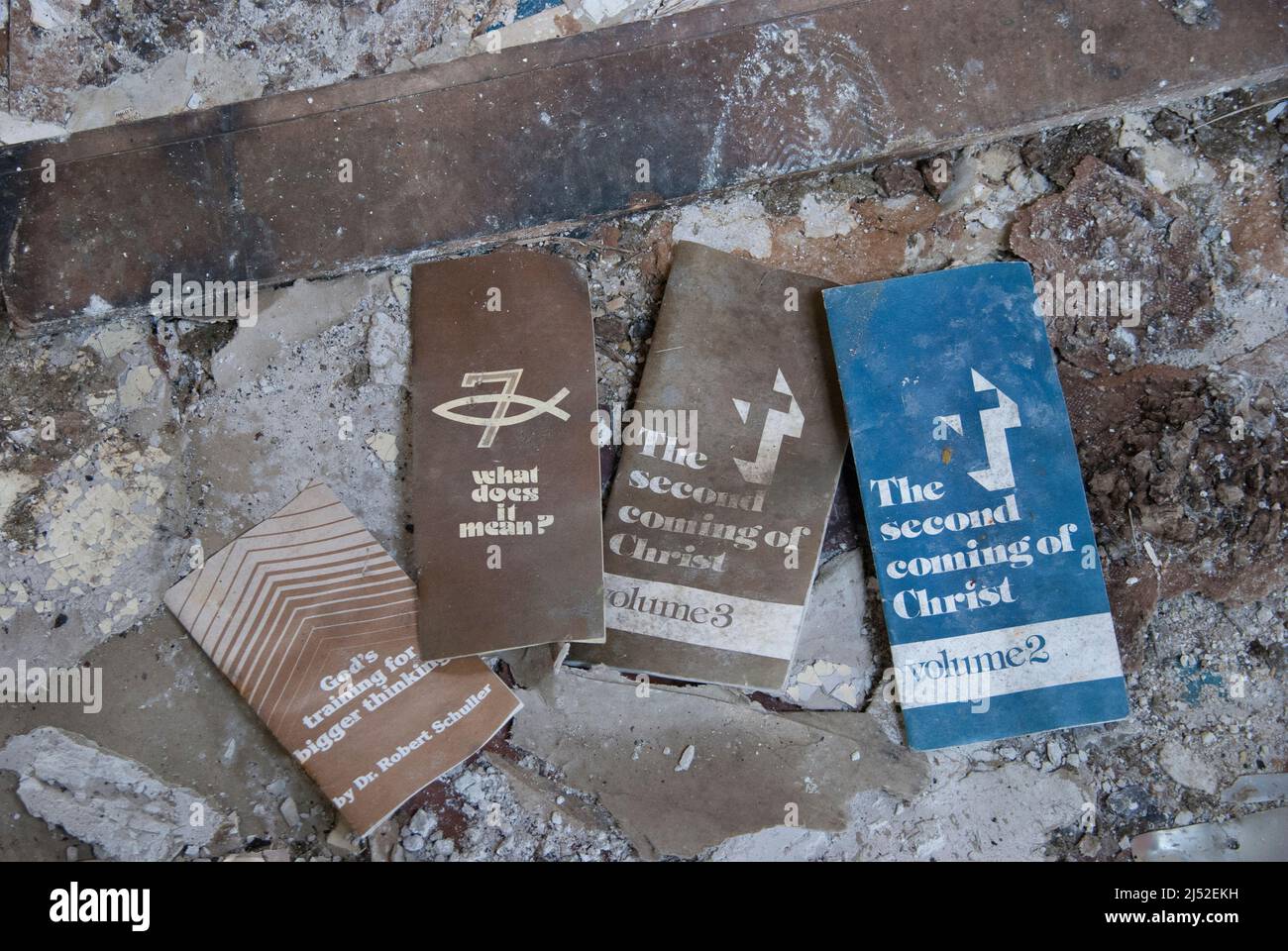 Religious leaflets with titles 'God's training for bigger thinking', 'What does it mean?', and 'The second Coming of Christ' inside a derelict church. Stock Photo