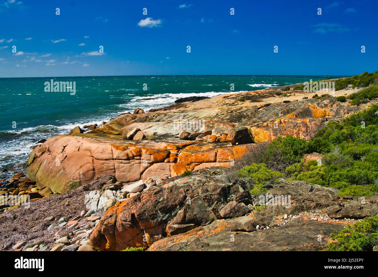 The wild coast, with red lichen covered rocks, of Donington Peninsula, part of Lincoln National Park, Eyre Peninsula, South Australia Stock Photo