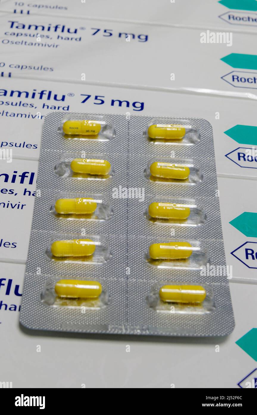 Blister pack of Tamiflu (Osteltamivir) capsules, 30mg, sitting on top of boxes of Tamiflu 75mg still in shrink wrapping, ready to be dispensed Stock Photo
