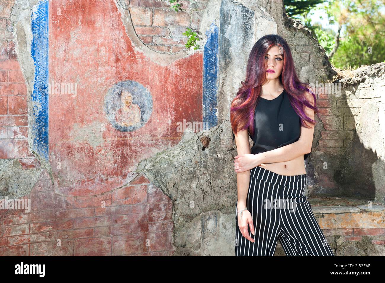 Red hair model in front of ancient roman mosaic Stock Photo