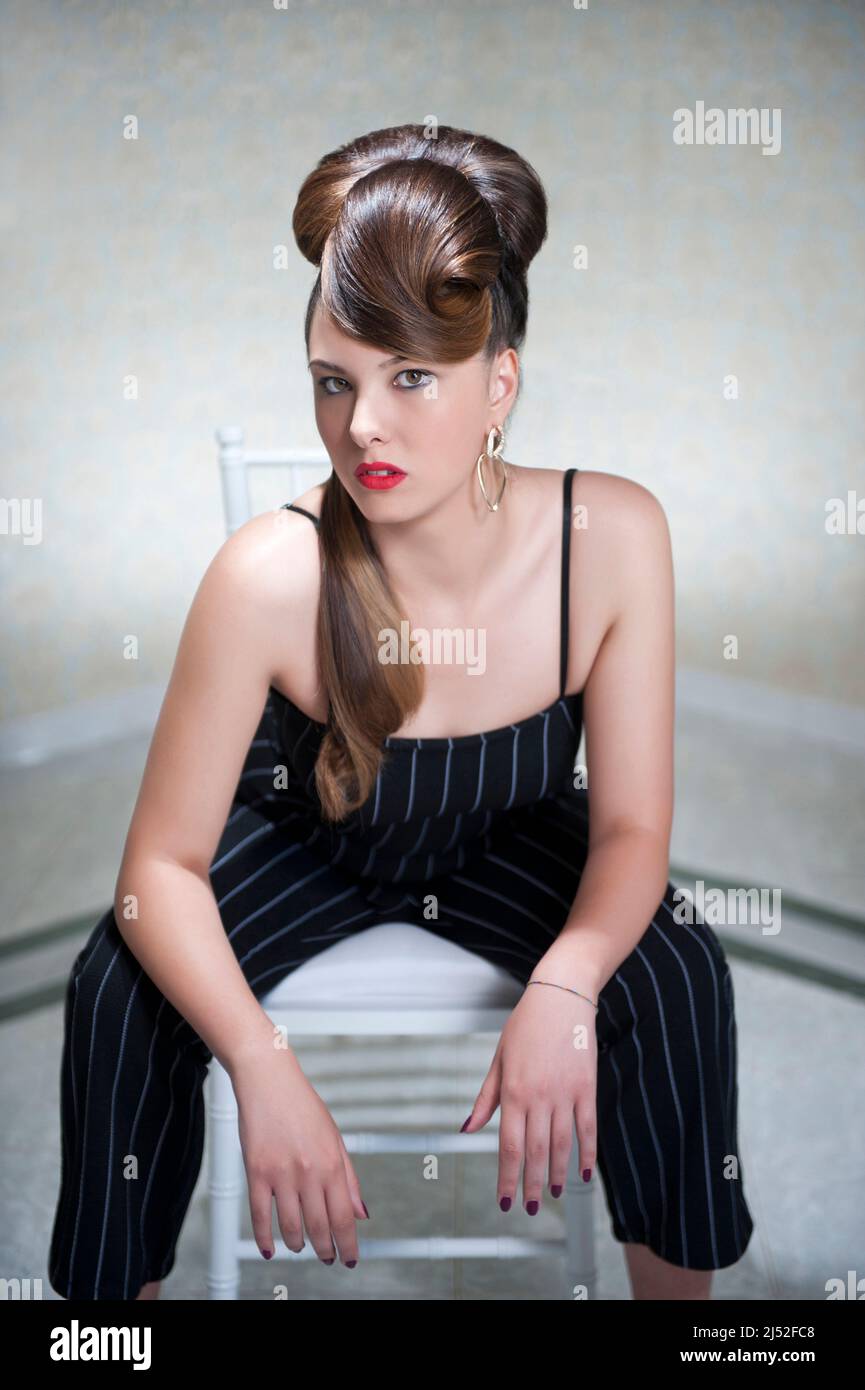 Brunette posing on a chair Stock Photo