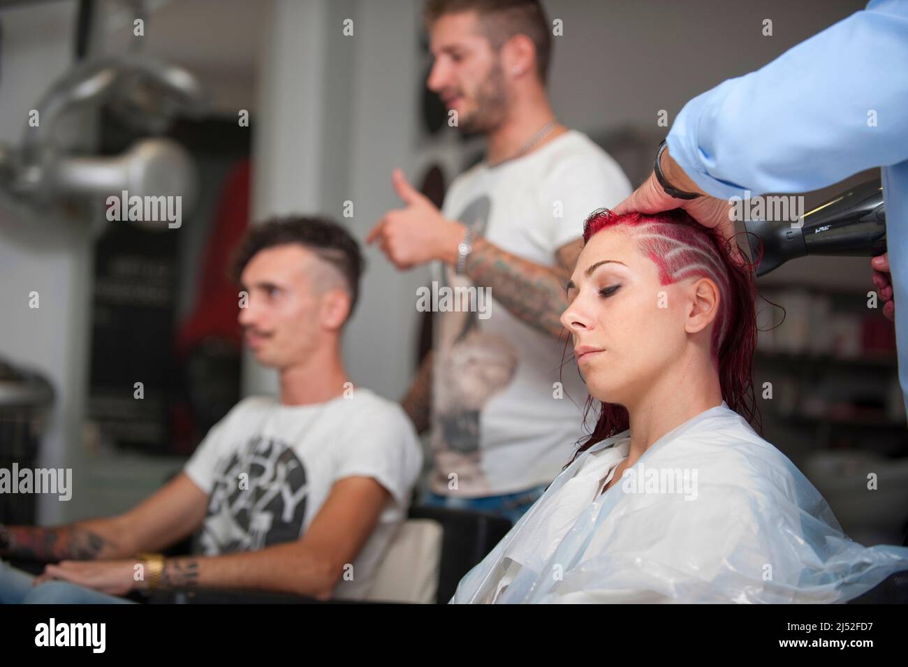 Hairstylist working on a red haircut Stock Photo