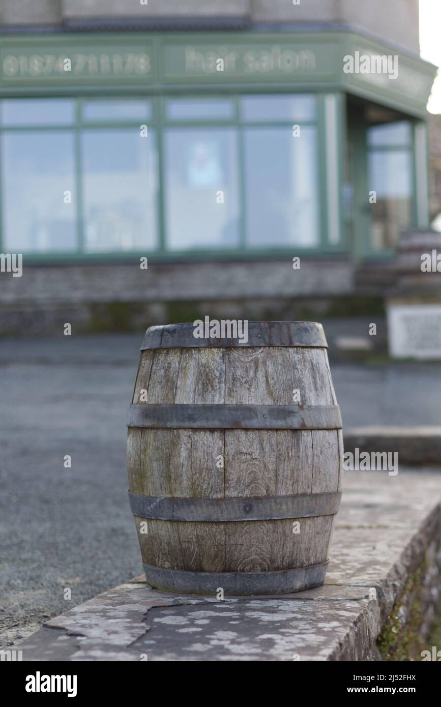 wooden barrel on a stone wall Stock Photo