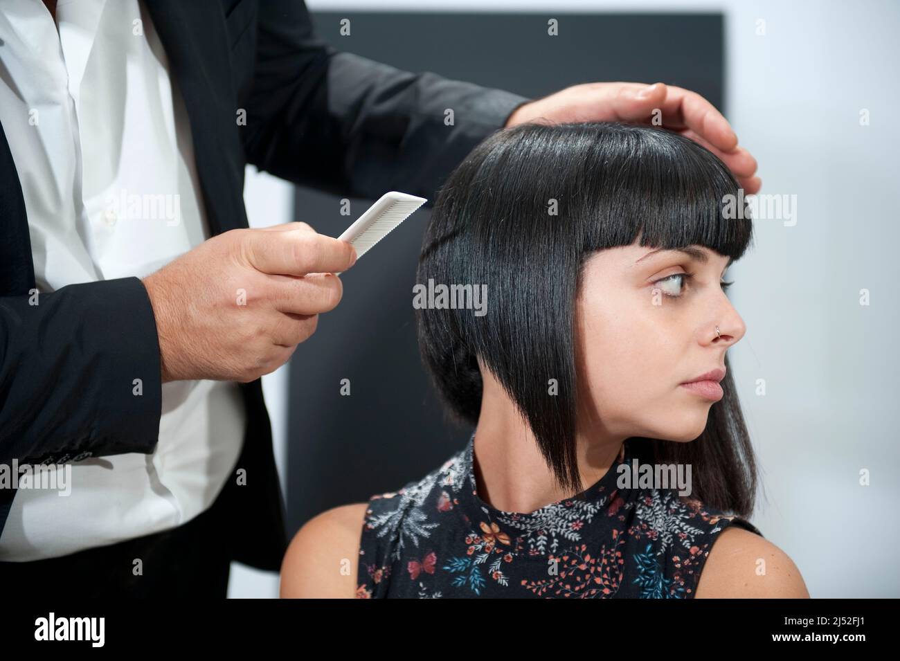 Hairstylist working on bob haircut Stock Photo