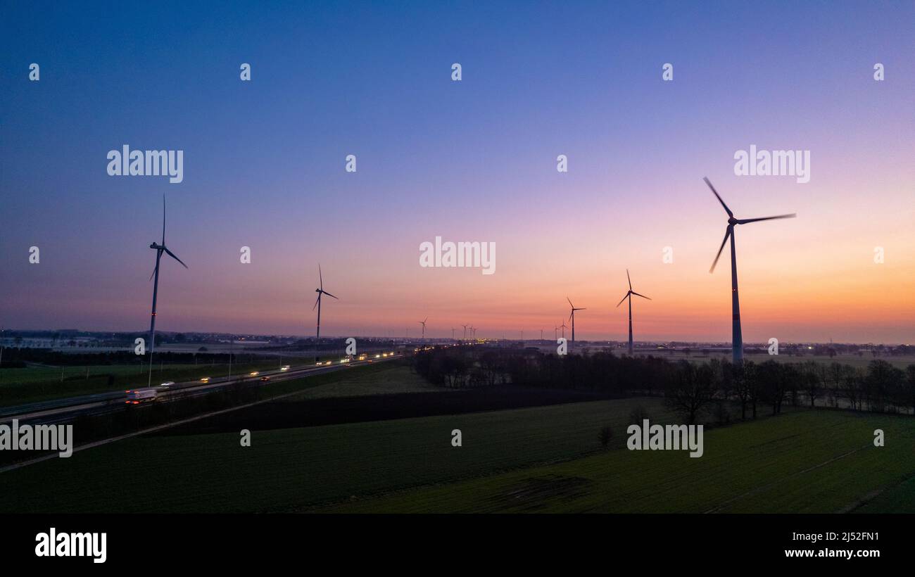 Silhouette of Wind turbines field against sunrise or sunset sky ...