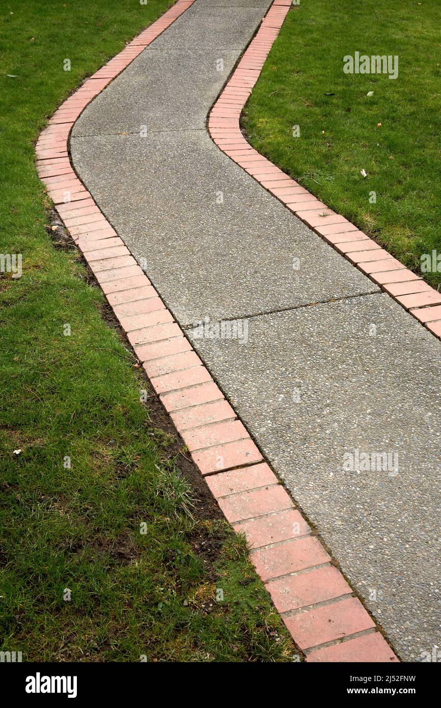 Closeup of a bending concrete and stone footpath Stock Photo