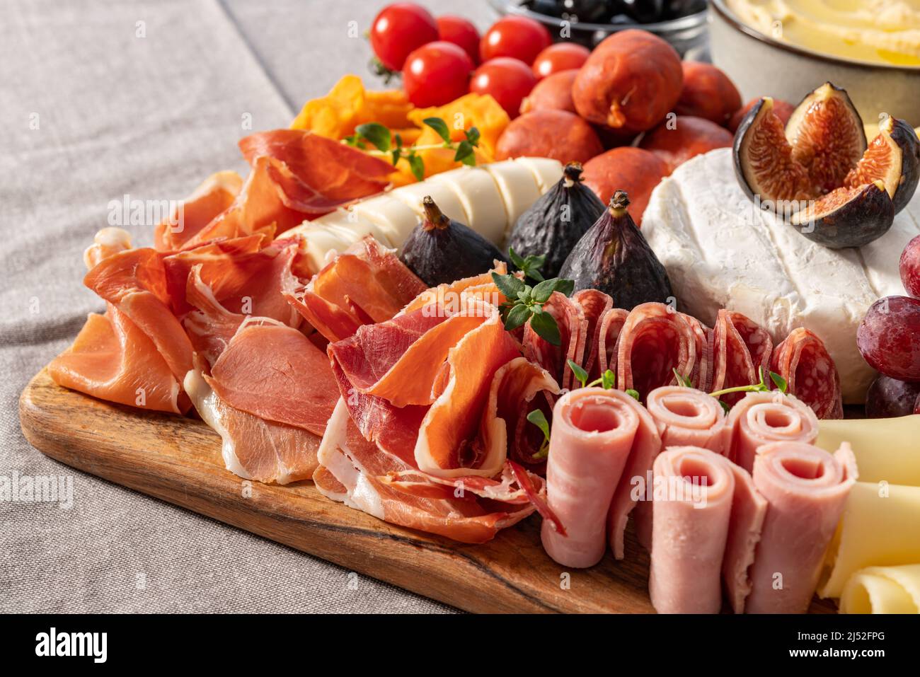 Cured cheese and meze platter setup rich in variety of fruits, cheese