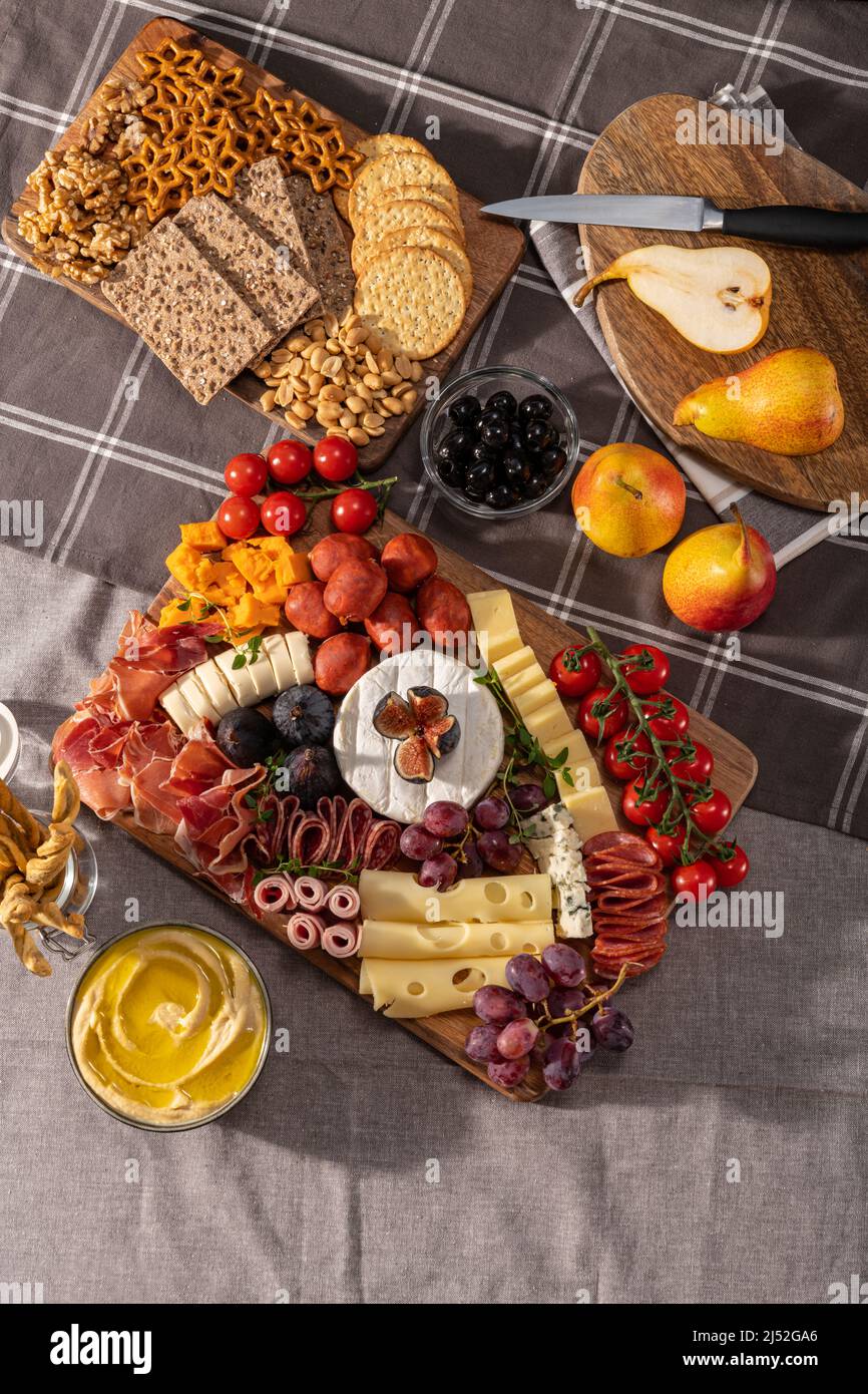 Cured cheese and meze platter setup rich in variety of fruits, cheese