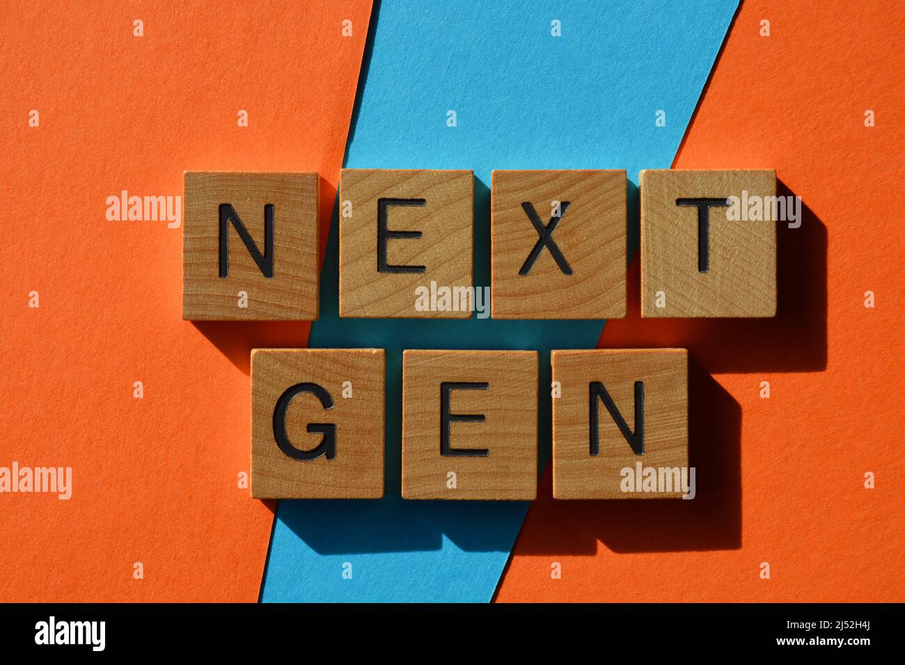 Next Gen, words in wooden alphabet letters isolated on colourful background Stock Photo