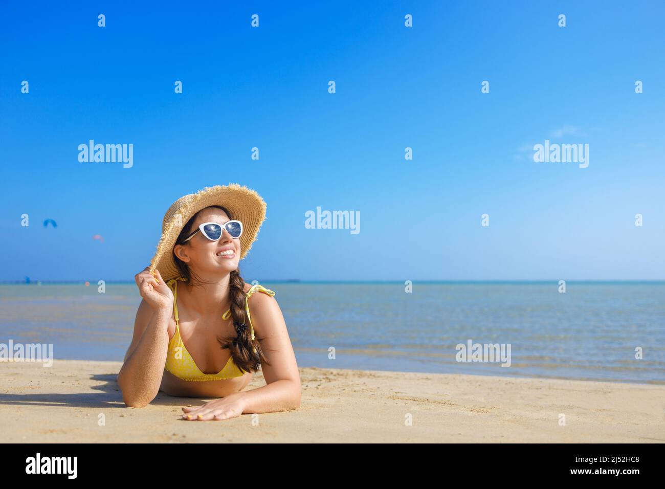 Woman in bikini lying on beach hi-res stock photography and images - Alamy