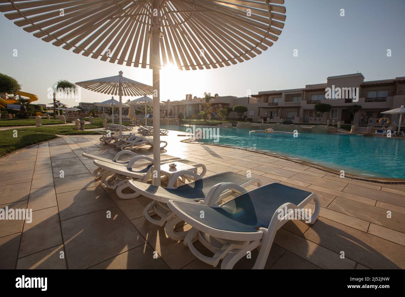 Hurghada, Egypt - October 1, 2019: sunshade umbrellas and sunbeds near pool in Jaz Casa Del Mar Resort in Hurghada, Egypt Stock Photo