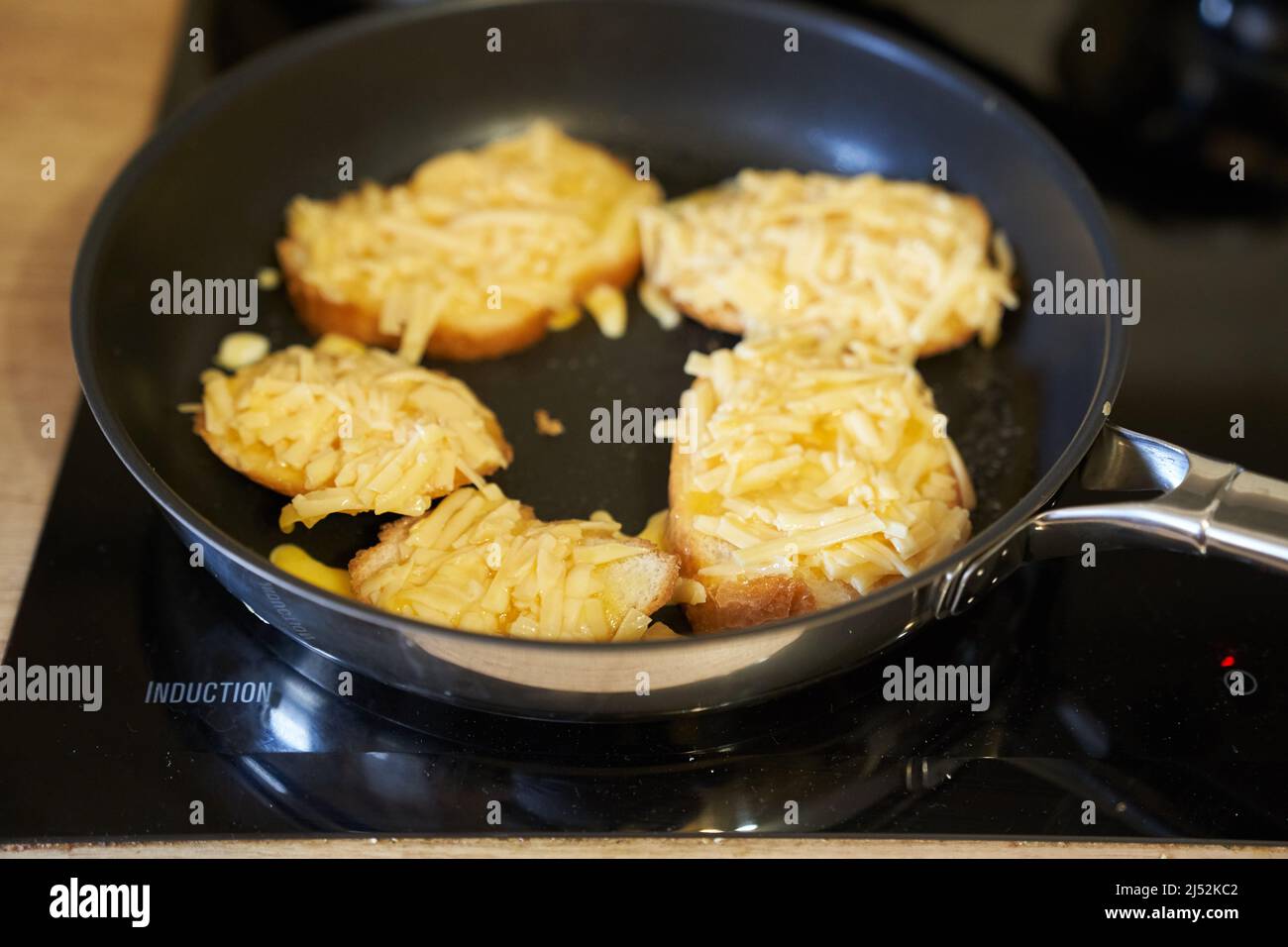 Delicious fried bread with an egg in a frying pan. Hot homemade sandwich step-by-step preparation. High quality photo Stock Photo