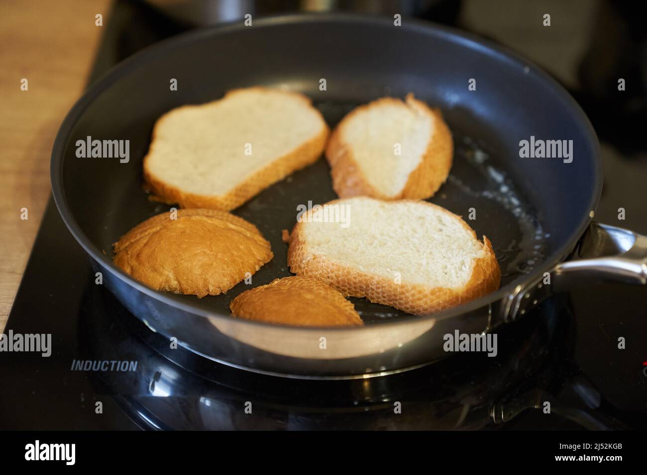 Delicious fried bread in a frying pan. Hot homemade sandwich step-by-step preparation. High quality photo Stock Photo